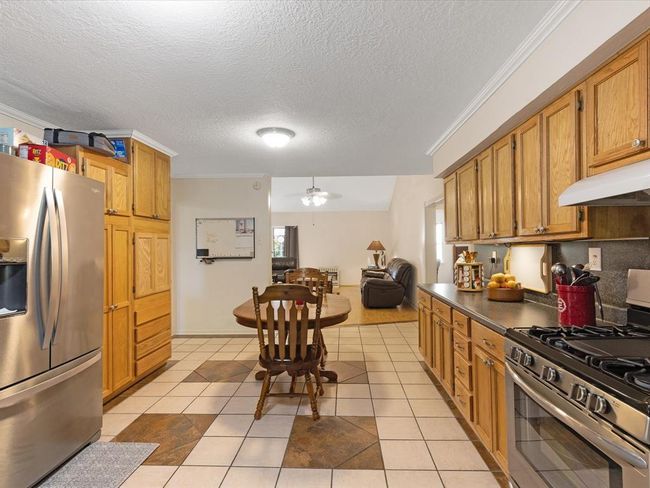 Stainless appliances including gas 5-burner range | Image 12