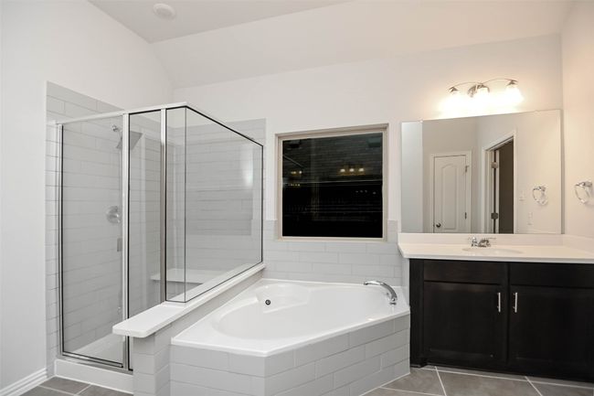 Full bath with a garden tub, a stall shower, tile patterned flooring, and vanity | Image 18