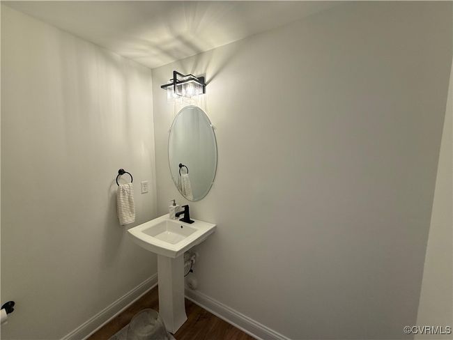 Bathroom featuring wood finished floors and baseboards | Image 19