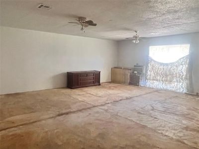 Spare room with ceiling fan and carpet floors | Image 3