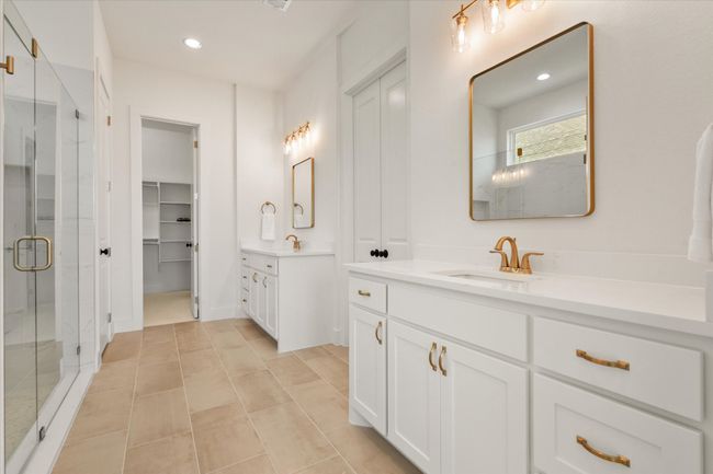 Primary bathroom with access to the closet that connects to the laundry room. | Image 16