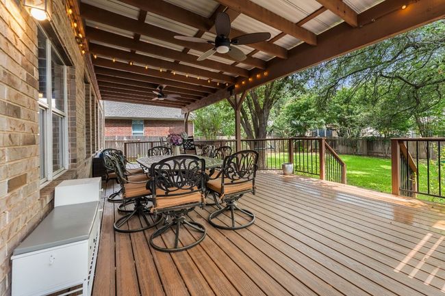 Deck with a ceiling fan and outdoor dining space | Image 33
