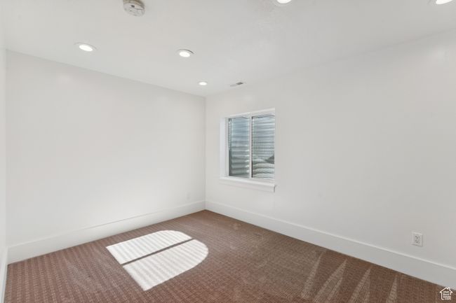 Carpeted empty room featuring a smoke detector and recessed lighting | Image 29