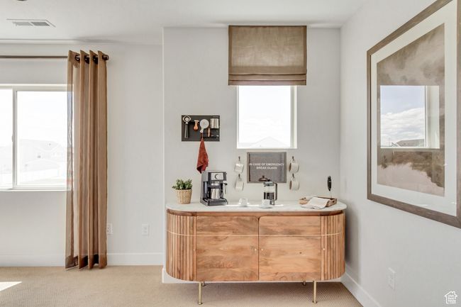 Bar with light colored carpet and healthy amount of natural light | Image 5