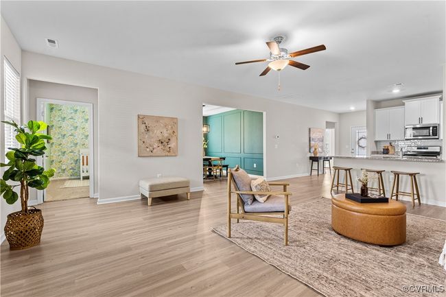 Living area with light wood finished floors, ceiling fan, baseboards, and recessed lighting | Image 24