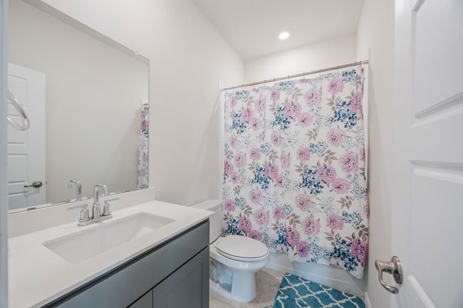 Bathroom featuring vanity, tile patterned flooring, and shower / tub combo with curtain | Image 18