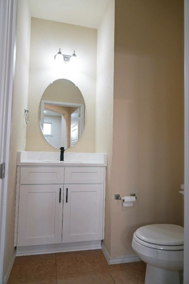 New quartz countertops and New cabinets installed in the half bathroom | Image 11