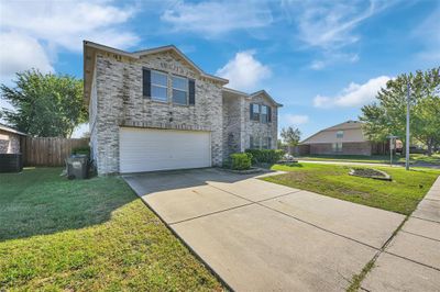 View of front of home featuring cooling unit, a front yard, and a garage | Image 3