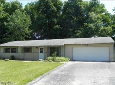 Single story home featuring a garage and a front yard | Image 1