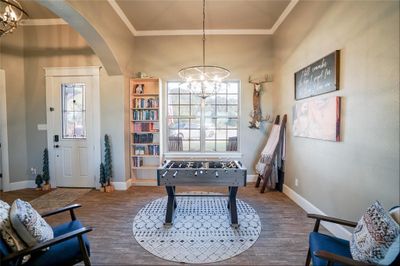 Rec room featuring crown molding, a notable chandelier, and hardwood / wood-style flooring | Image 3