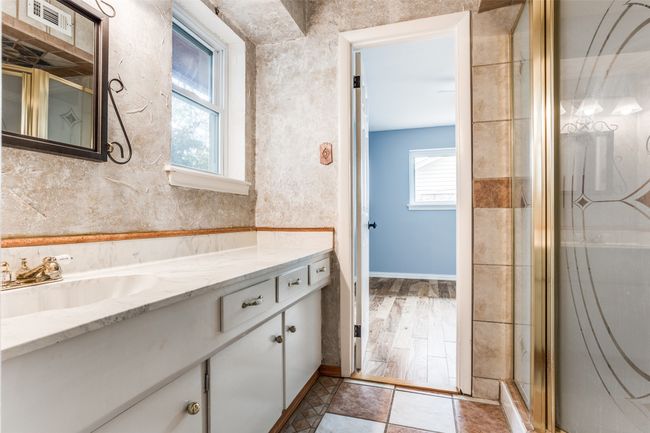 Bathroom featuring vanity, baseboards, and a shower with door | Image 35
