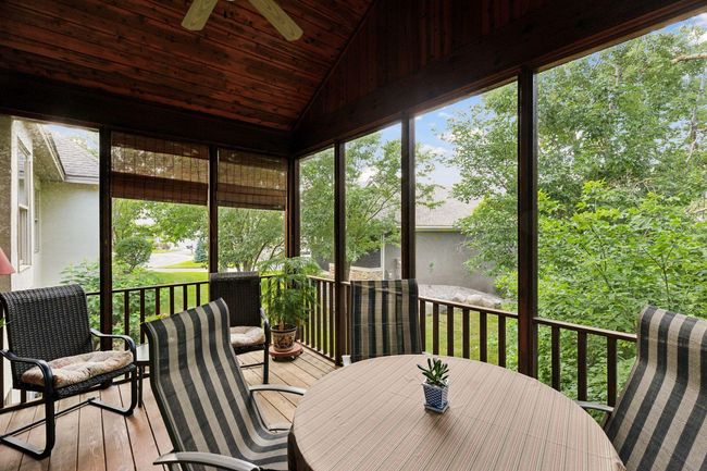 Screened porch and deck with a natural gas grill conveniently located just steps away from the kitchen and family room. | Image 16