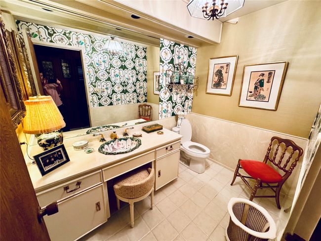 Bathroom with a chandelier, tile patterned floors, toilet, wallpapered walls, and vanity | Image 29