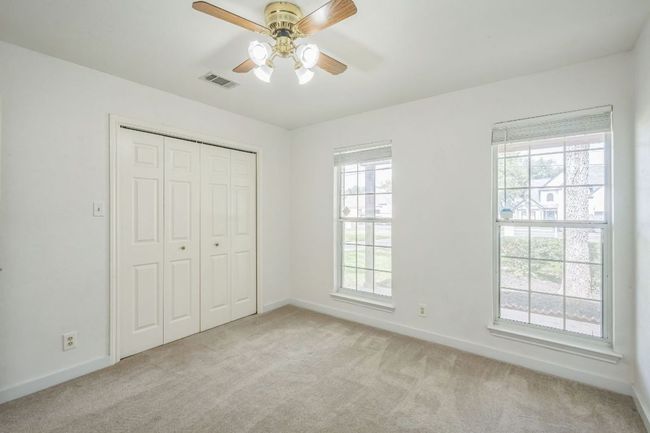 Bedroom with fan, large closet and multiple windows | Image 21