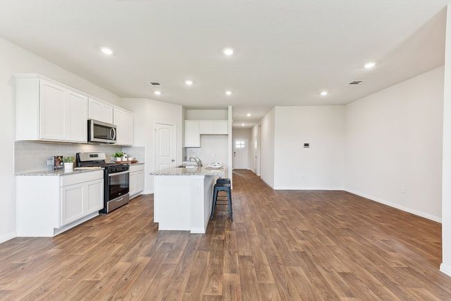 Heart of the Home: A spacious kitchen with granite countertops, sleek cabinetry, and a stylish backsplash. | Image 11