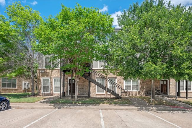 View of property with stairway and uncovered parking | Image 16
