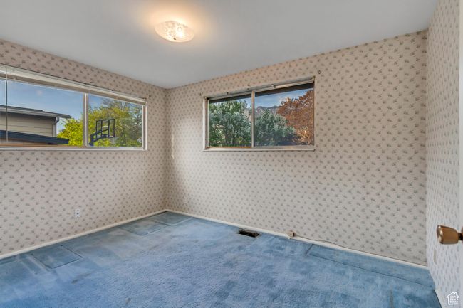 Spare room featuring visible vents, wallpapered walls, baseboards, and carpet flooring | Image 16