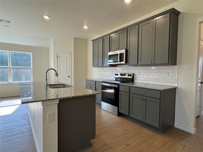 Kitchen features granite countertops, & stainless-steel appliances | Image 2