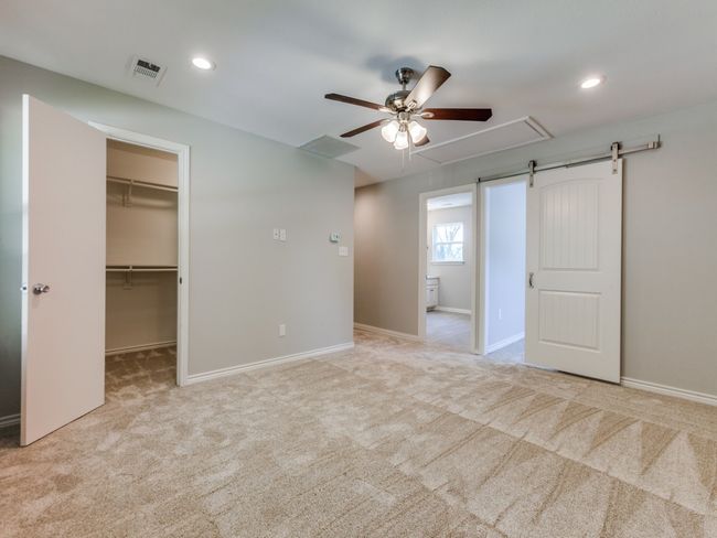 Unfurnished bedroom with carpet flooring, a spacious closet, recessed lighting, baseboards, and a ceiling fan | Image 14
