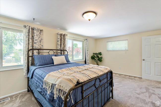 Bedroom featuring light colored carpet and multiple windows | Image 41