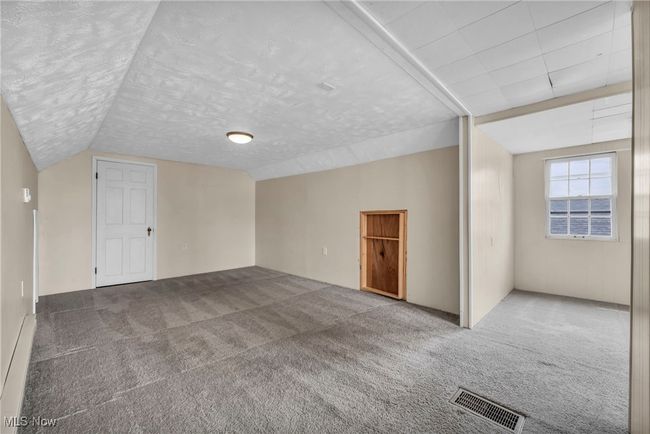 Bonus room with lofted ceiling, visible vents, and carpet | Image 42