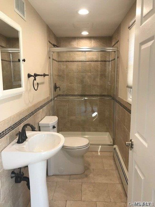 Full bath with toilet, a stall shower, tile walls | Image 14