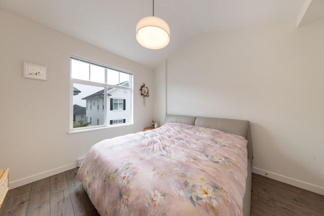 Bedroom with vaulted ceiling, hardwood / wood-style floors, and baseboards | Image 13