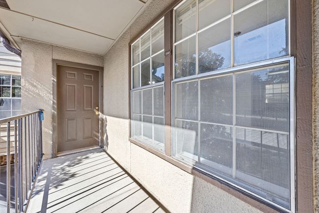 Doorway to property with a balcony and stucco siding | Image 18