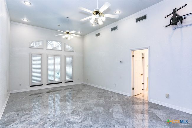 Primary bedroom on the first floor with big windows and wooden shutters. | Image 17