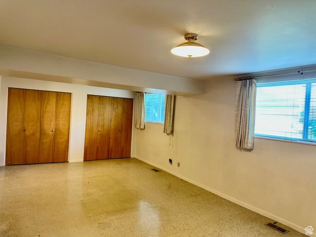 Large family room with baseboards and multiple closets | Image 16