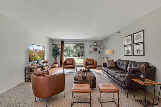 The kitchen opens up to the dining space and beautiful views of the lawn and trees. | Image 4