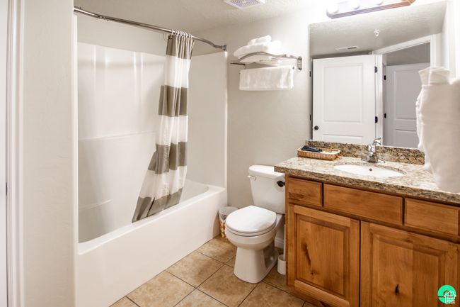 Bathroom featuring vanity, shower / bath combo and cleaning closet | Image 20