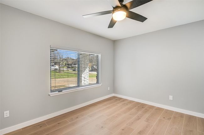 Spare room with hard tile light wood-style flooring and a ceiling fan | Image 15