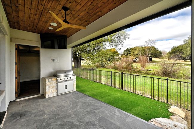 View of patio / terrace featuring an outdoor kitchen, fence, and a grill | Image 33
