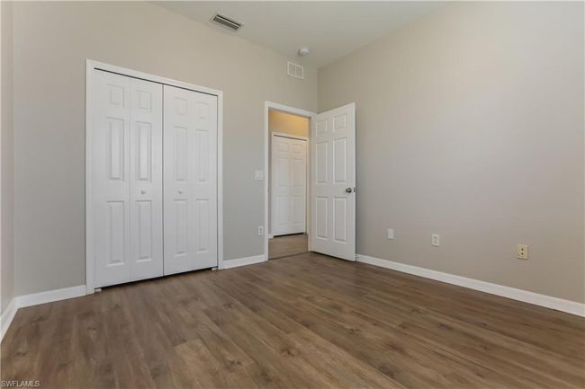 Unfurnished bedroom featuring wood finished floors and a closet | Image 8