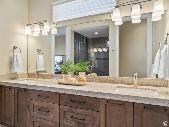 Full bath featuring double vanity, a shower stall, and plenty of natural light | Image 11