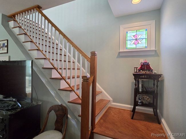 Stairway featuring baseboards and wood finished floors | Image 28