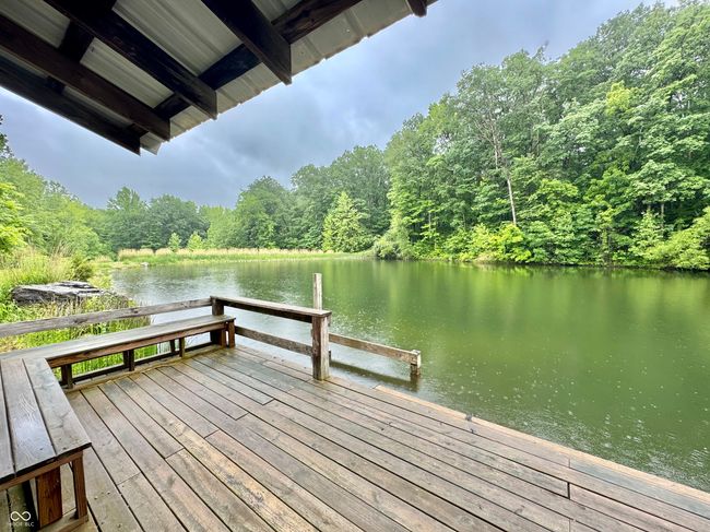 dock area featuring a forest view and a water view | Image 31