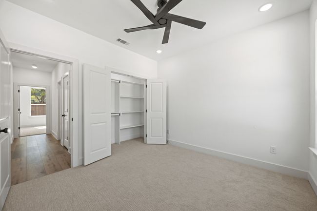 Unfurnished bedroom featuring recessed lighting, a closet, baseboards, ceiling fan, and light carpet | Image 23