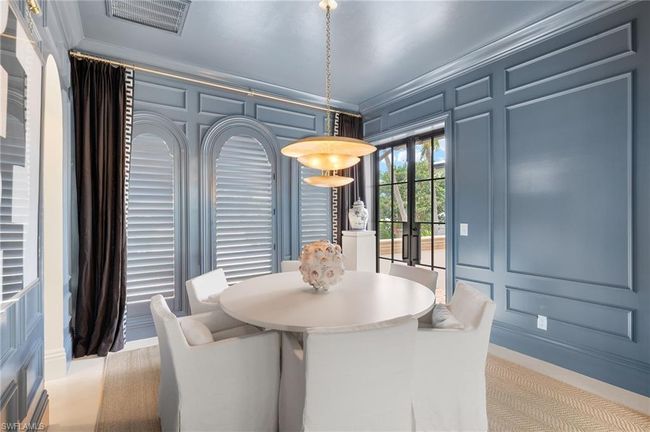 Dining space with crown molding, visible vents, and a decorative wall | Image 16