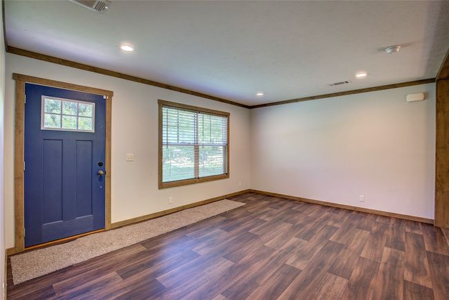 Foyer entrance featuring ornamental molding, dark wood finished floors, and recessed lighting | Image 10
