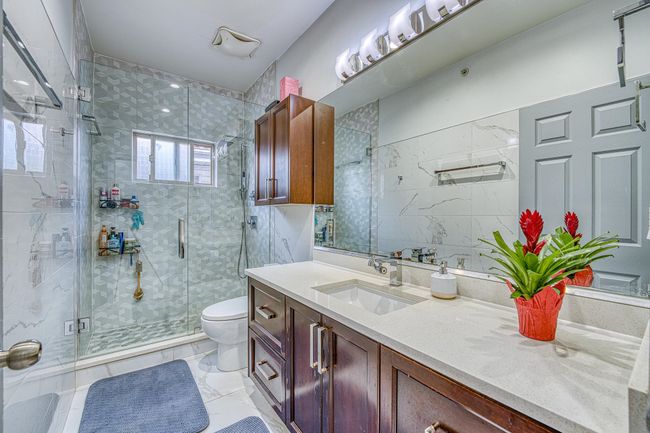 Bathroom featuring vanity, a stall shower, and marble finish flooring | Image 14