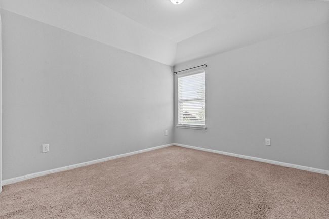 Empty room featuring carpet floors, lofted ceiling, and baseboards | Image 21