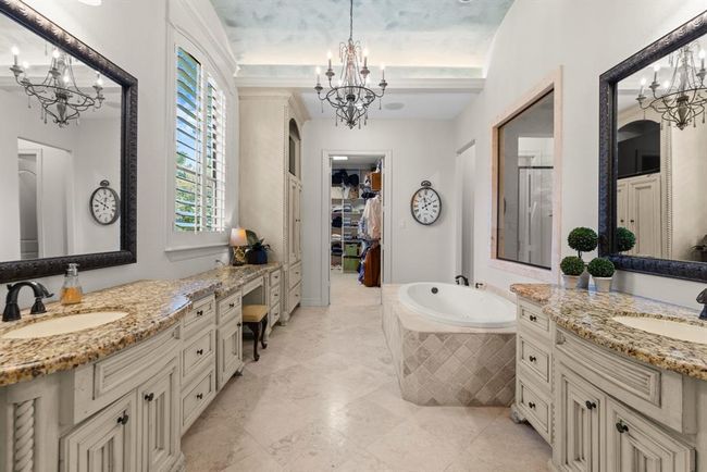 The spa-like bath beckons to you...over-sized jacuzzi tub , double sinks, vanity space, and a large walk-in closet! | Image 32
