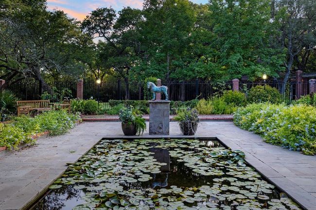 [The Garden of the Blue Horse]. The 5-acre homesite is surrounded by lush English gardens, vegetable gardens and pathways leading to outdoor entertaining spaces. These meticulously curated spaces bestow a tranquility to both owners and guests alike. Underground irrigation has been installed throughout the lawn and gardens. | Image 6