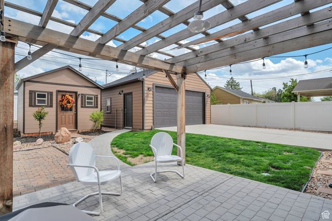 View of patio / terrace with fence, driveway, and a pergola | Image 23