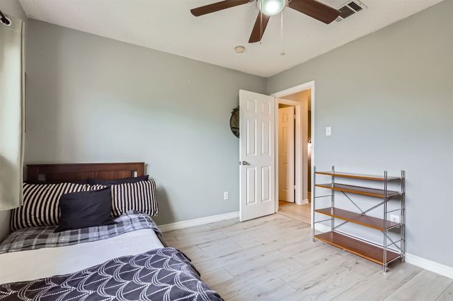 Bedroom with wood finished floors, baseboards, and ceiling fan | Image 21