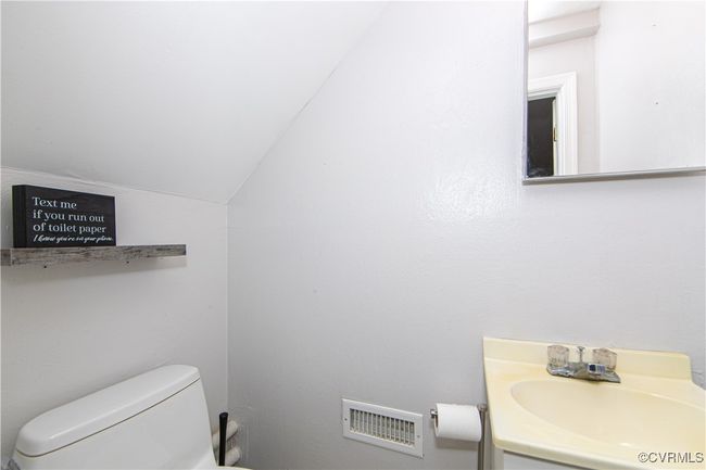 Bathroom featuring vanity, vaulted ceiling, and toilet | Image 10