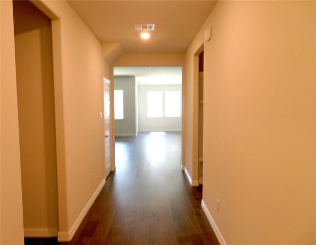Entry hallway leads to the open kitchen and family room | Image 4