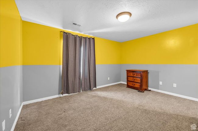Unfurnished room featuring baseboards, visible vents, carpet floors, and a textured ceiling | Image 10
